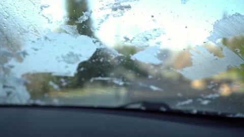 Cleaning the car windshield from ice with a brush Stock Footage 300544826