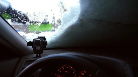 Cleaning car windshield from snow with brush Video stock 100877825