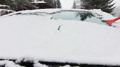 Cleaning car windshield on the snowfall Stock Footage 295416381