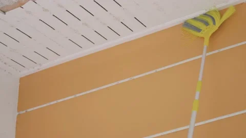 Cleaning ceiling cobwebs with an extension broomstick. Stock Footage 170225703
