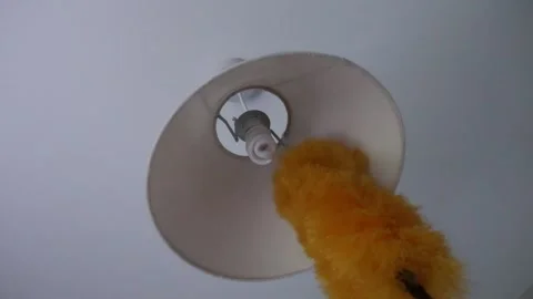 Cleaning chores in the home dusting ceiling light and shade Video stock 146446609