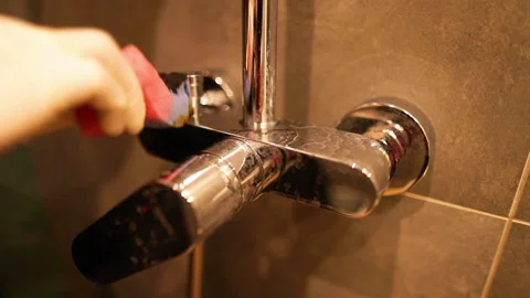Cleaning chrome faucets in the bathroom. Stock Footage 237839488