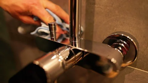 Cleaning chrome faucets in the bathroom. Stock Footage 237839621
