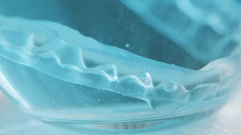 Cleaning clear orthodontic aligners with a tablet cleaner. Stock Footage 327851669