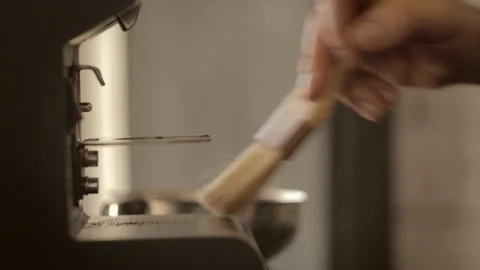 Cleaning coffee grinder with brush Stock Footage 111992043