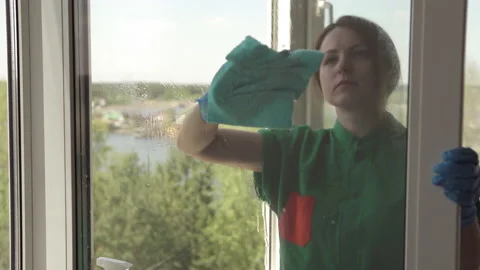 Cleaning company worker washes windows using detergent. Stock Footage 194544451