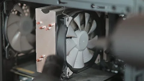 Cleaning a computer cooling fan inside the case. A close-up of a technician 스톡 동영상 337112790
