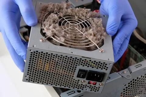 Cleaning  computer from dust. Gloved hands keep dust covered parts. Foto stock
