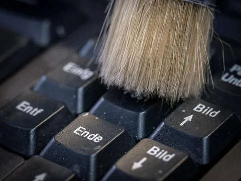 Cleaning the computer keyboard with a brush Stock Photos