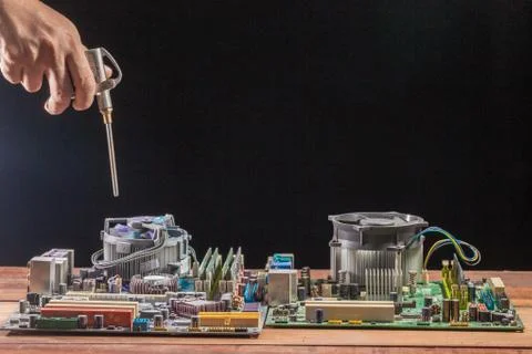 Cleaning the computer mainboard using air compressor Stock Photos