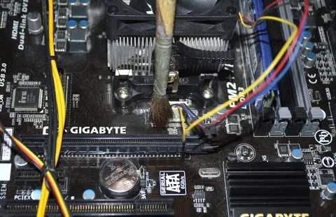 Cleaning the computer system unit with a dust brush. system unit maintenance Stock Photos