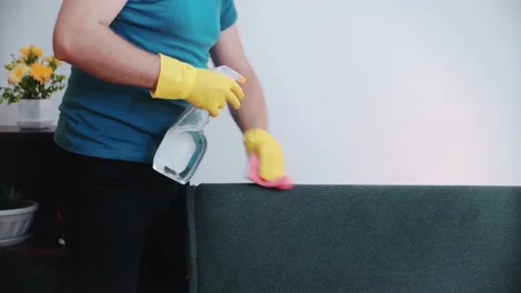 Cleaning concept. A man cleans the sofa in the room, close-up. Stock Footage 148569272