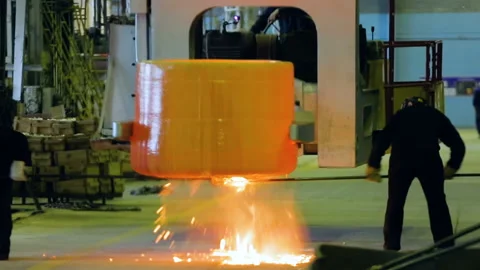 Cleaning of a container for liquid metal. Two workers clean the container for Video stock 92494557