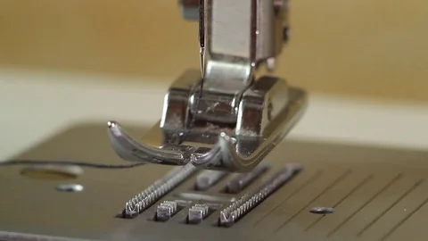 Cleaning the conveyor and sewing machine feet from debris Stock Footage 82354646