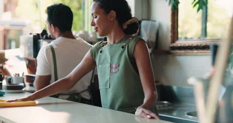 Cleaning, counter and waitress with cloth in cafe, hygiene and disinfection for Stock Footage 330991683