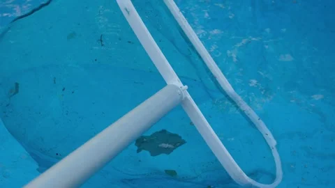 Cleaning debris from the pool surface. Pool net for catching debris. Stock Footage 340187958