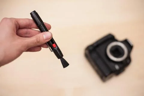 Cleaning digital camera with brush Stock Photos