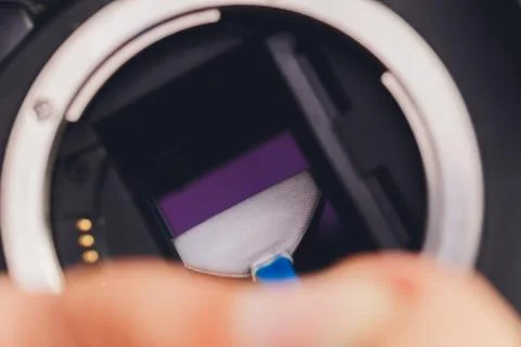 Cleaning dirty camera sensor. Digital photo camera with cleaning tools. Stock Photos