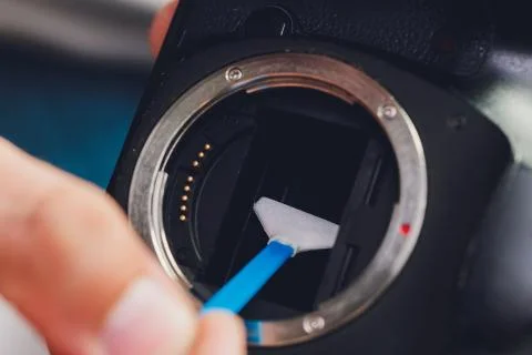 Cleaning dirty camera sensor. Digital photo camera with cleaning tools. Stock Photos