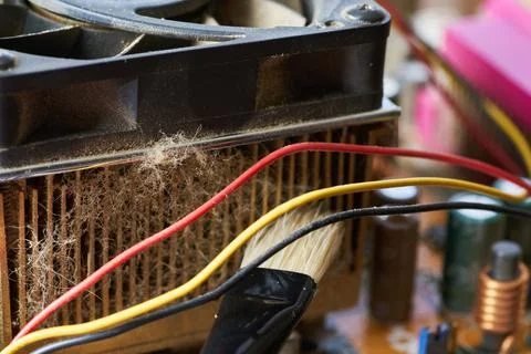 Cleaning dirty desktop computer processor fan from dust by special brush clos Stock Photos