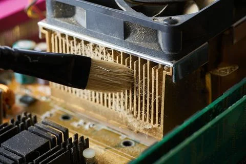 Cleaning dirty desktop computer processor fan from dust by special brush clos Stock Photos