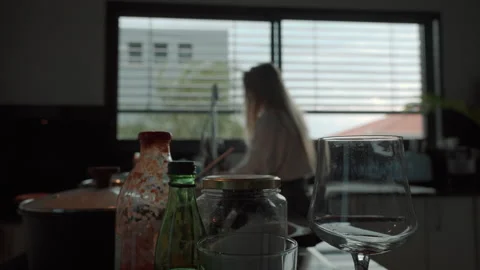 Cleaning dirty dishes in the kitchen while enjoying the morning light Stock Footage 321378898