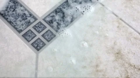 Cleaning a dirty floor tile Stock Footage