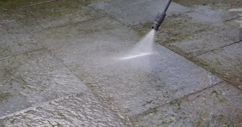 Cleaning a dirty garden path with a pressure washer. Close-up. Vídeos de archivo 332680910