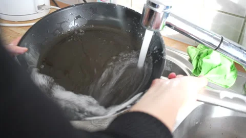 Cleaning dirty pan in the sink, using water and soap Stock Footage 260115834