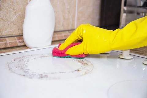 Cleaning Dirty Stove Surface With Scrubber Sponge Stock Photos