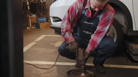 Cleaning disc brake on car, in process of new tire replacement. Car brake Stock Footage 243712423