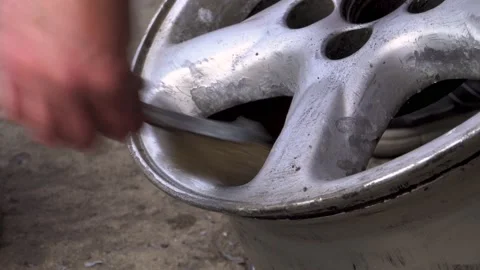 Cleaning the disc with a wire brush 4K Stock Footage 196735339