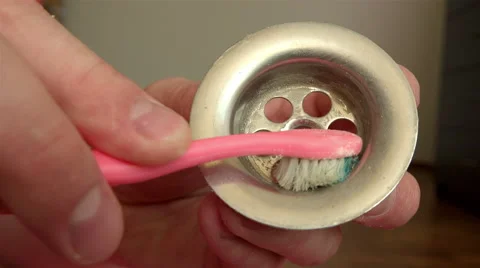 Cleaning the docking ring from the sink using soda and toothbrush Stock Footage 61777123