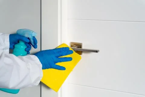Cleaning door handles with an antiseptic during a viral epidemic Stock Photos