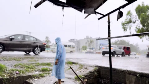 Cleaning of Drain During Heavy Rainfall Stock Footage 332761268