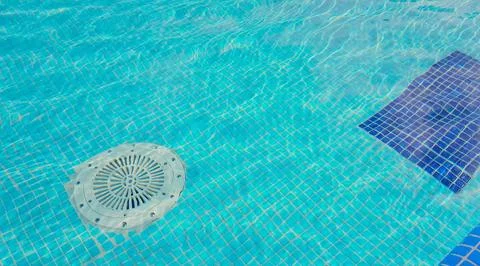 Cleaning of the drain valve filter at the bottom of the swimming pool, move.. Stock Photos
