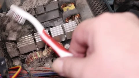 Cleaning dust from electronic components of a computer power supply Vídeos de archivo 304724160