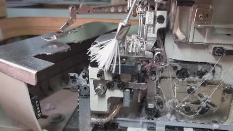 Cleaning the dust from the overlock machine with a brush . Maintenance of Stock Footage 314787545