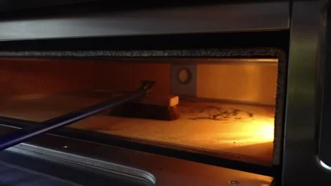 Cleaning an electric oven with a broom, kitchen cleaning Stock Footage 274234976