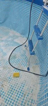 Cleaning Empty Above Ground Frame Pool with Soap Foam, Sponge and Ladder Stock Photos