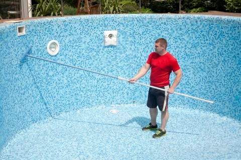 Cleaning an empty swimming pool Stock Photos