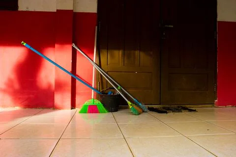 Cleaning equipment is placed in front of the elementary school door Stock Photos