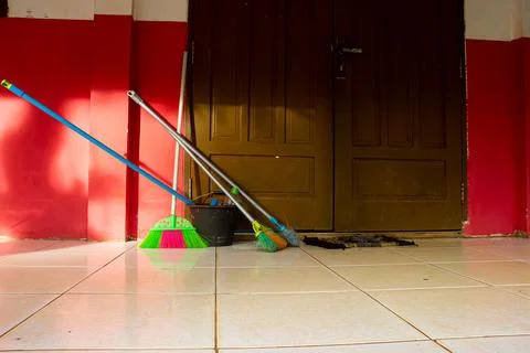 Cleaning equipment is placed in front of the elementary school door Stock Photos
