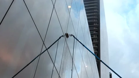 Cleaning the facade of a glass building with an extendable brush Stock Footage 136852010