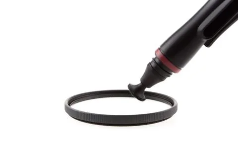 Cleaning a filter of camera with a tool Foto stock