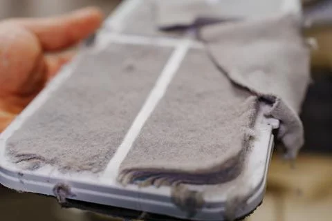 Cleaning the filter in the dryer machine . Stock Photos