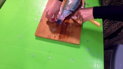 Cleaning fish on a cutting board. Stock Footage 76687558