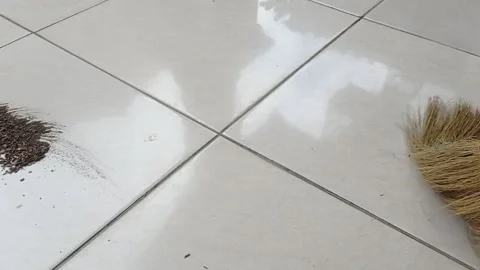 Cleaning the floor with a brown broom Stock Footage 146254022