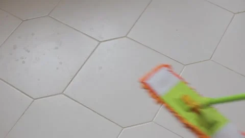 Cleaning the floor with a mop and rag. Cleaning tiles with a mop. Stock Footage 266898653