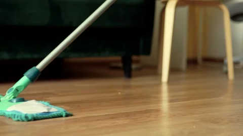 Cleaning the floor with a mop closeup. Hosehold and clean home concept. Stock Footage 301976464